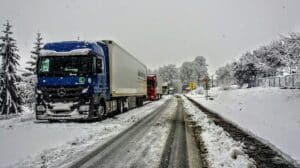 commercial trucks driving in snow